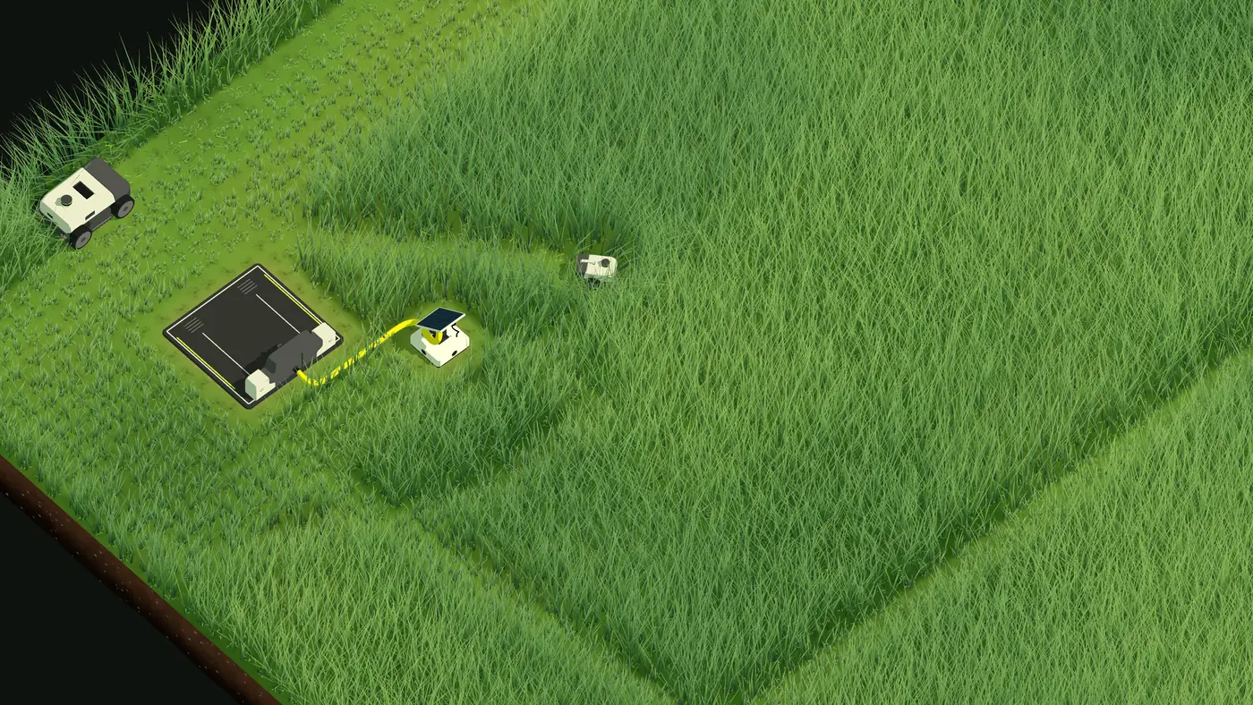 The first plot: a charger cabled to a small solar panel, a Ranger mowing along the edge and a Scout cutting into the tall grass.